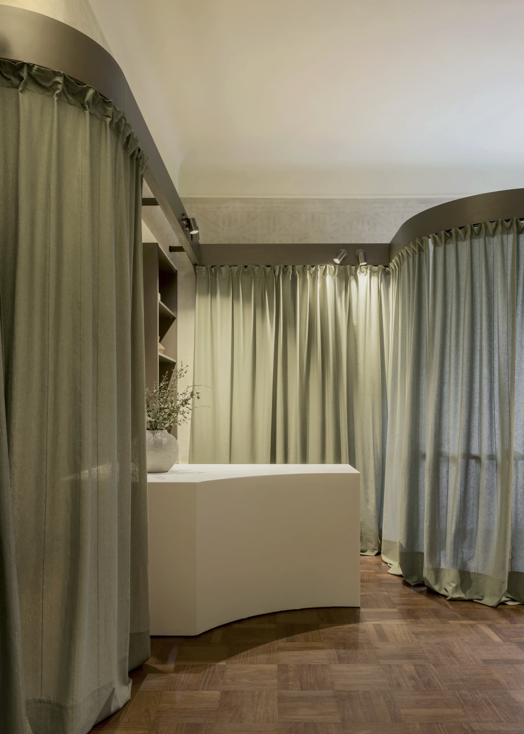 Sage curtains meeting a curved rail at HY Brera