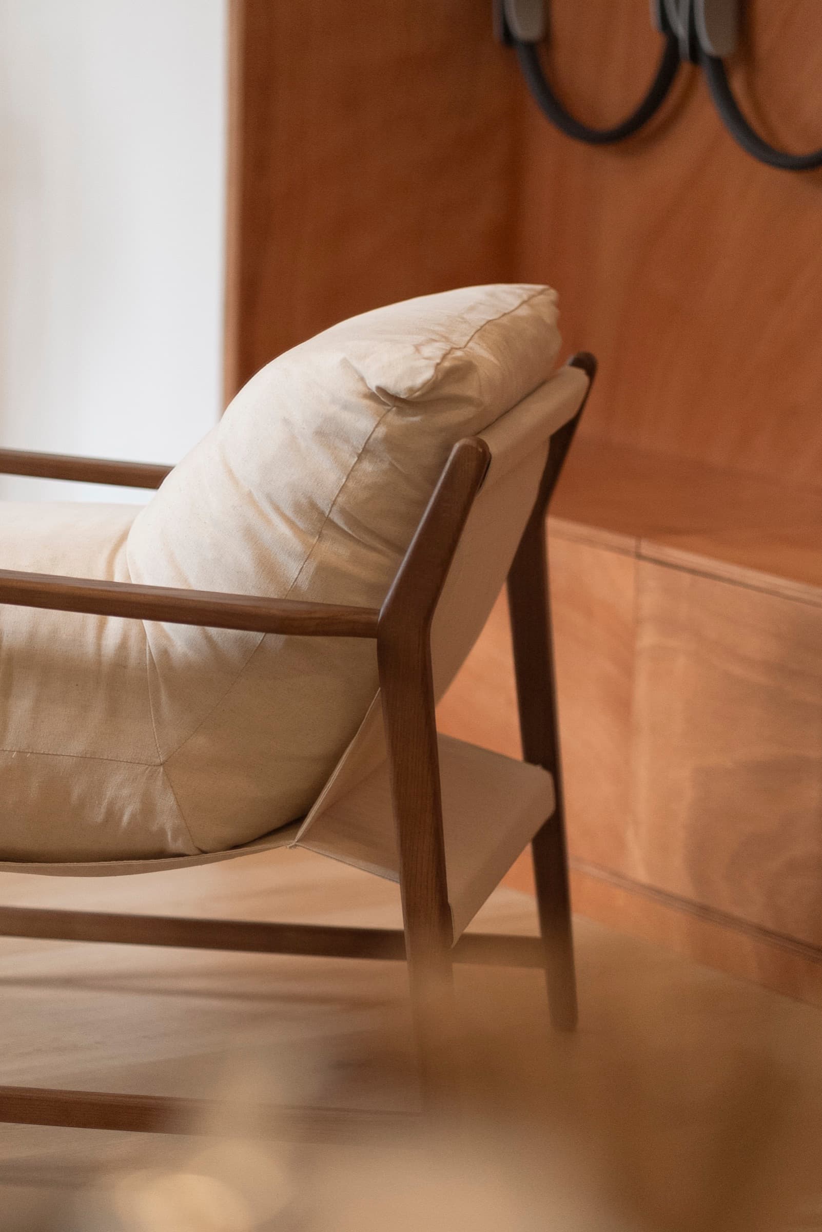 Wood-framed armchair detail at HY Guastalla