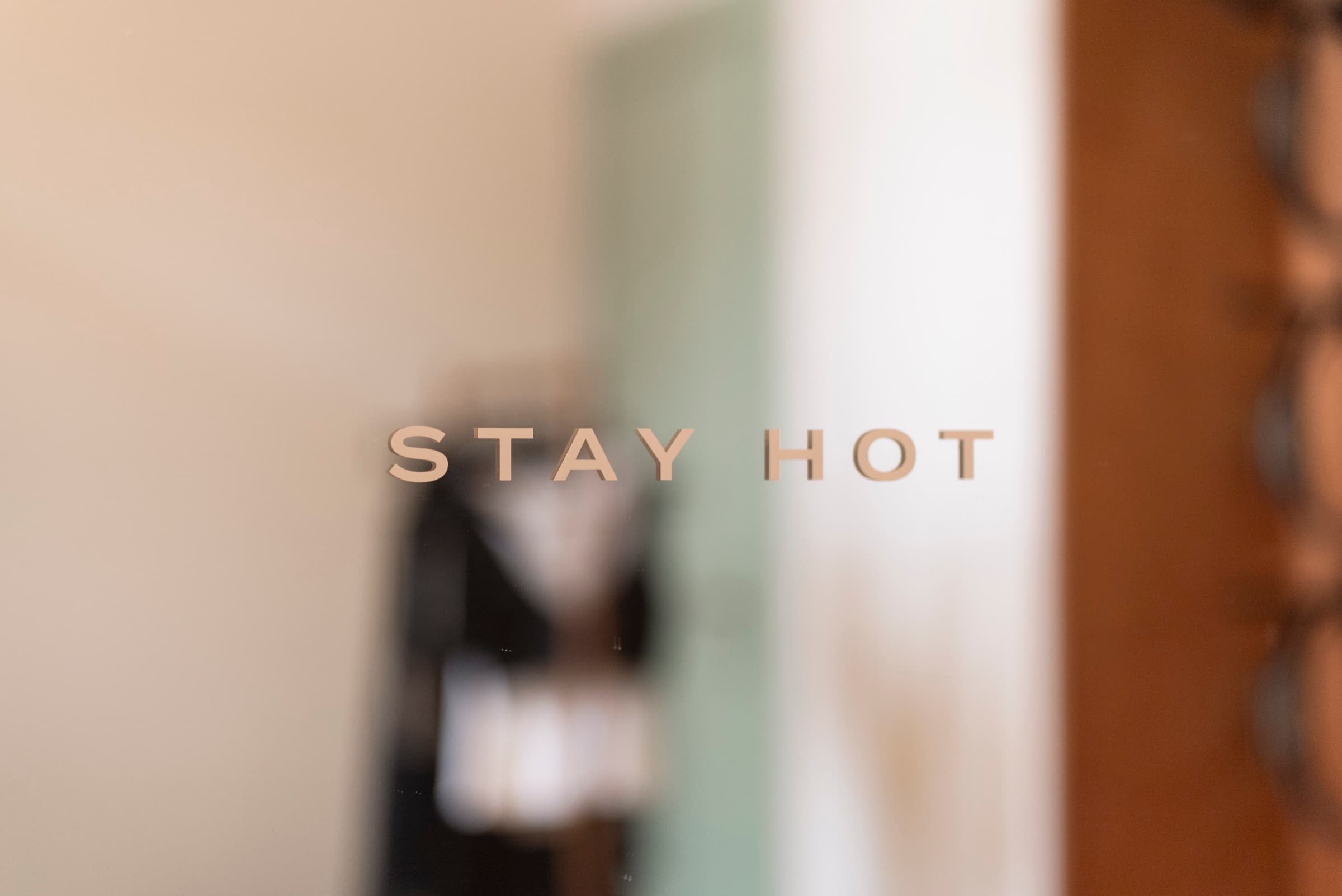 Stay Hot lettering on a mirrored wall at HY Guastalla